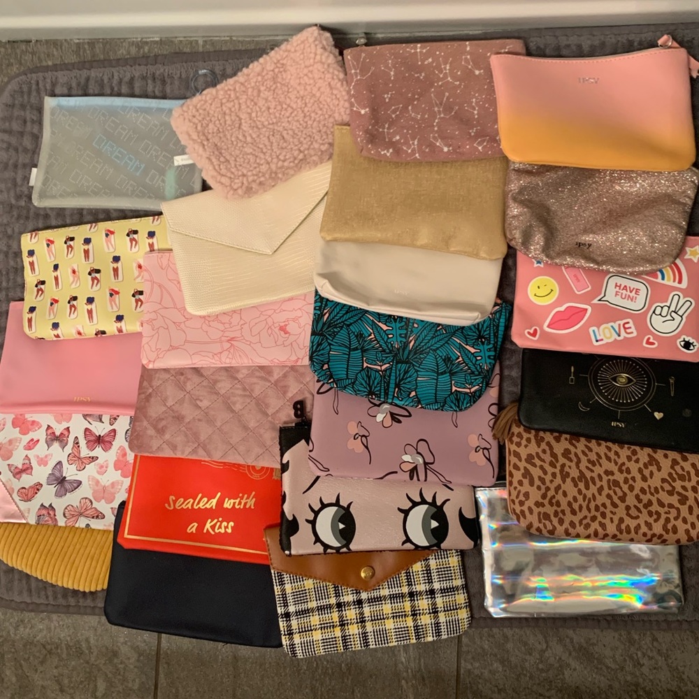 24 various Ipsy makeup bags